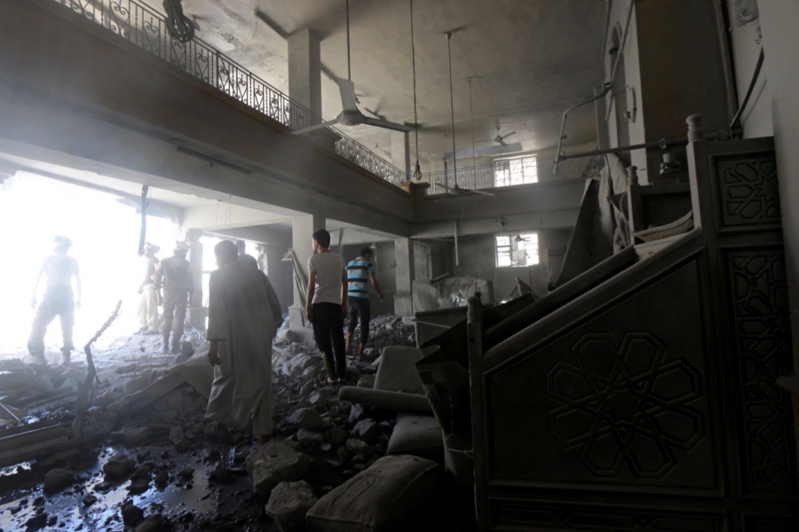 Civil defense members and residents inspect damage inside al-Aqsa mosque after an airstrike on the rebel held Al-Hilwaniyeh neighborhood in Aleppo on July 14. Civil defense members and residents inspect damage inside al-Aqsa mosque after an airstrike on the rebel held Al-Hilwaniyeh neighborhood in Aleppo on July 14.